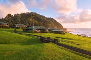 a house on a hill next to the ocean at Hana-Maui Resort, a Destination by Hyatt Residence in Hana