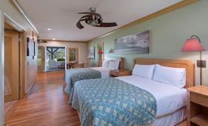 a hotel room with a bed, chair, and nightstand at Hana-Maui Resort, a Destination by Hyatt Residence in Hana