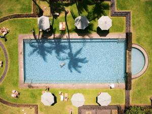 an overhead view of a swimming pool with umbrellas at Hana-Maui Resort, a Destination by Hyatt Residence in Hana