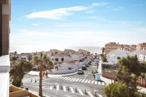 a view of a street in a town with the ocean at La Perla D23 By Médano Rentals in El Médano