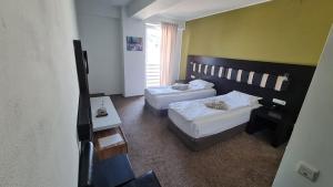 Postel nebo postele na pokoji v ubytování Hotel Sydney