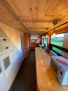 a train car with a long line of tables at Sleeps 18 Double Decker Bus Hot Tub Sauna Cinema Pets in Irvinestown