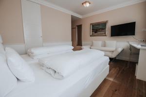 Postel nebo postele na pokoji v ubytování Boutique Hotel am Rathaus - Reblaus