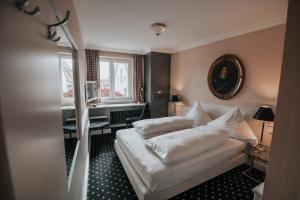 Postel nebo postele na pokoji v ubytování Boutique Hotel am Rathaus - Reblaus