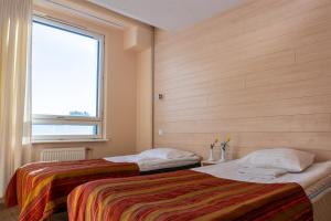 Voodi või voodid majutusasutuse Center Hotel toas +37 fotot