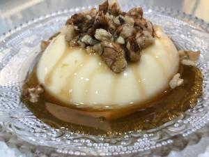 a dessert on a glass plate with nuts on it at Hotel Paradise in Bilisht