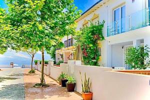 a white building with trees and plants in front of it at Stylish Beach House in La Cala de Mijas 5 star location few steps from Butibamba Beach in La Cala de Mijas