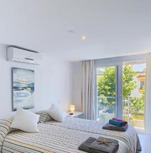a bedroom with a bed with two towels on it at Stylish Beach House in La Cala de Mijas 5 star location few steps from Butibamba Beach in La Cala de Mijas