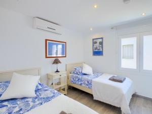 a bedroom with two beds and a window at Stylish Beach House in La Cala de Mijas 5 star location few steps from Butibamba Beach in La Cala de Mijas