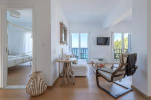 a living room with a chair and a table at Uno Apartment 1st Floor in Livadia