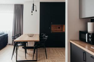 a kitchen and a dining room with a table and chairs at apartament Czorsztyn WIDOK - pierwsza linia brzegowa - 3 piętro - widok na jezioro - in Kluszkowce +33 photos