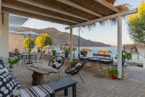 a patio with a table and chairs and the ocean at Uno Apartment 2 in Livadia