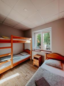 a bedroom with two bunk beds and a window at Hostel Filip in Gdańsk