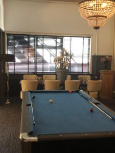 a pool table in a living room with a pool table at Hotel Norg in Norg