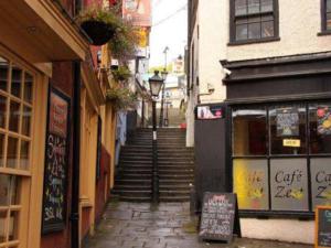 a narrow alley with stairs leading up to a building at Quirky and Cool Christmas Steps 2 bed in Bristol