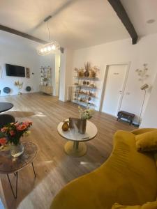 a living room with a yellow couch and a table at Baby Hotel in Turin