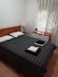 a bedroom with a bed with two towels on it at Casa el Olivo in Mazarrón