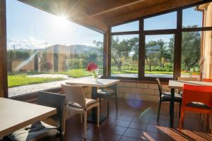 un restaurante con mesas y sillas y una gran ventana en BB Domus Catanzaro, en Catanzaro