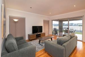 a living room with two couches and a television at The Lookout in Dunsborough