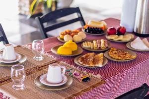 a table topped with plates of food on a table at Villa Ondas in Barra Grande