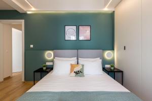 Posteľ alebo postele v izbe v ubytovaní IO SUITES
