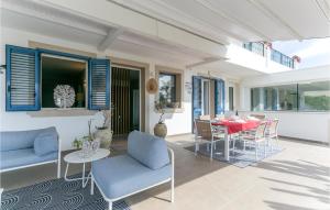 d'une terrasse avec une table, des chaises et des volets bleus. dans l'établissement Villa Terraforte, à Marina di Ragusa