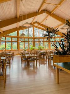 a dining room with wooden tables and chairs at Aktiv-Hotel Stock & Stein in Königstein an der Elbe