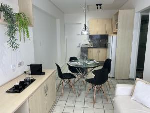 a kitchen and dining room with a table and chairs at Flat - Navegantes Residence Hotel in Recife