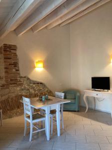 a dining room with a white table and chairs at Agriturismo San Michele in Vicenza