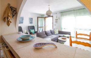 a kitchen and living room with a table with bowls on it at 3 Bedroom Gorgeous Home In El Campello in El Campello