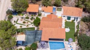 an overhead view of a house with a pool at Secluded house with seawater pool in Milna