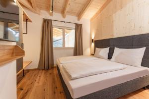 a bedroom with a bed and a window at Apartmentresort MyLodge in Schladming