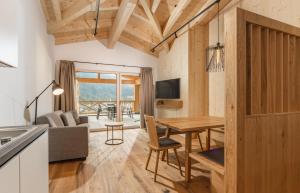 a kitchen and living room with a wooden table at Apartmentresort MyLodge in Schladming +58 photos