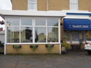 a restaurant with a window on the side of a building at The Sandhill in Sandown