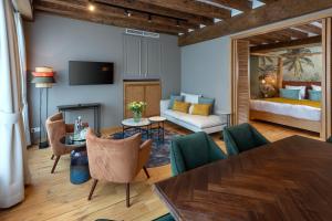 a living room with a bed and a table and chairs at Martin's Relais in Bruges