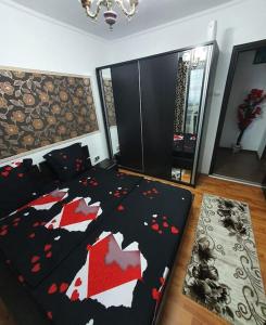 a bedroom with a large bed with red hearts on it at SWEET HOME & LiLiANA in Tecuci