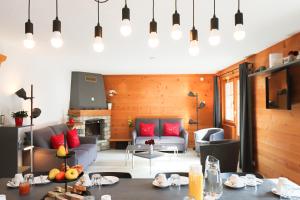 a living room with a couch and a table at Chalet La Pala avec SPA in Val-d'Illiez