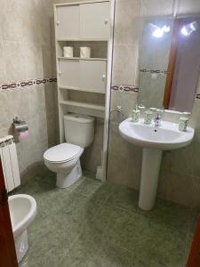 a bathroom with a toilet and a sink at Marisa Mored vivienda de uso Turistico in Laspaúles +7 photos