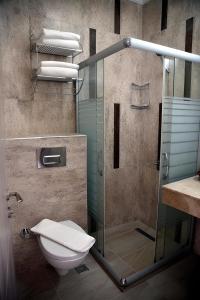 a bathroom with a glass shower and a toilet at Manuela Boutique Hotel Bitez in Bitez