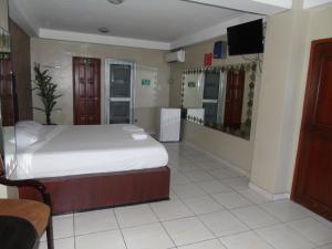 Postel nebo postele na pokoji v ubytování Hotel Queens