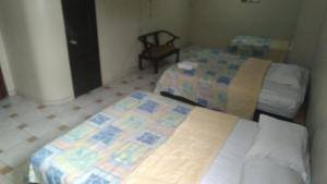 Postel nebo postele na pokoji v ubytování Hotel Queens