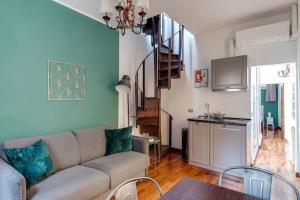 a living room with a couch and a table at In Piazza 'Apartments & Relax' in Ravenna