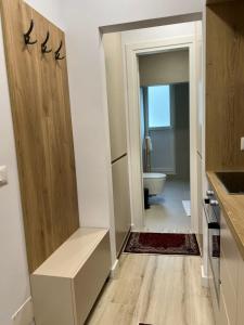 a bathroom with a toilet and a sink and a door at Smart Home , Lovely Apartment in Tirana in Tirana