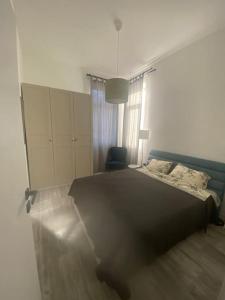 a bedroom with a bed and a chair at Apartment Vitosha vu Sofia in Sofia
