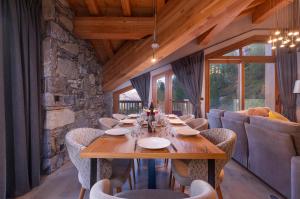 a dining room with a wooden table and chairs at Le Hameau des Oursons in Arc 1950