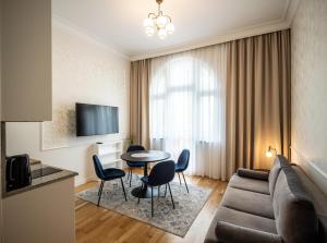 a living room with a couch and a table and chairs at Apartos Wisus - Luxury Apartments in Świnoujście