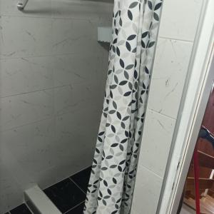a shower curtain with black and white geometric patterns at Apartman Stan na dan in Banja Koviljača +12 photos
