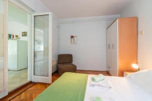 a bedroom with a bed and a sliding glass door at Apartment Violet in Jurandvor