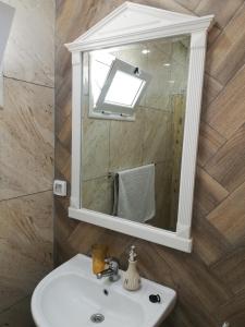 a bathroom with a sink and a mirror at Residence Debbabi in Monastir