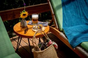 a small table with a glass of beer and a basket at Gocta Natura Reserve in Cocachimba +71 photos